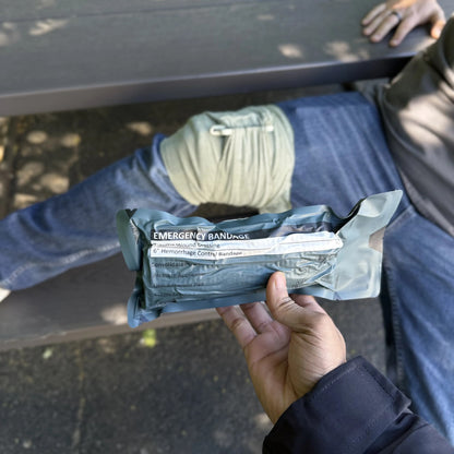 Trauma Bandage sealed pack held in hand, ready to open
