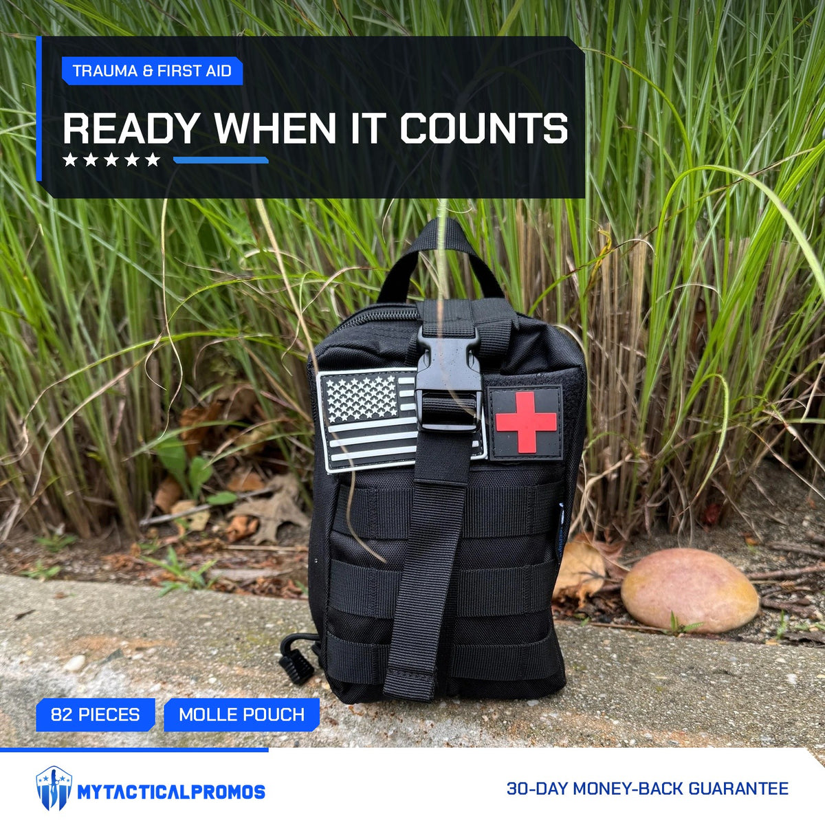 Trauma First Aid Kit MOLLE pouch with US flag and red cross patches outdoors by tall grass