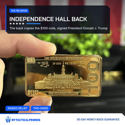 Back of the Trump $100 portrait gold-plated bar showing Independence Hall, held in hand