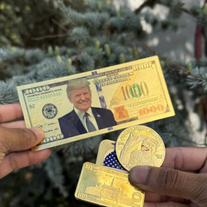 Trump $1000 gold foil novelty bill held outdoors by an evergreen, other keepsakes sold separately