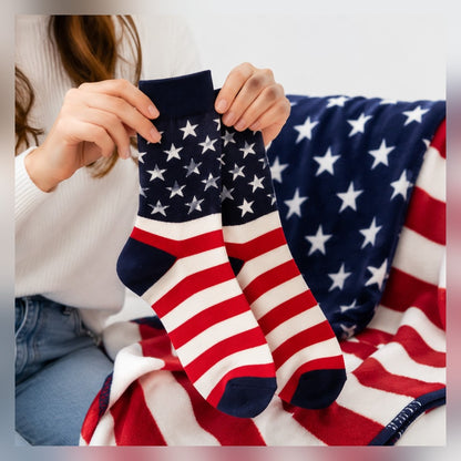 American Flag Socks pair held up over a flag blanket