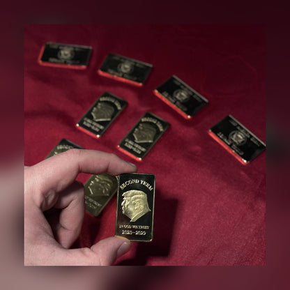 Trump Second Term gold-plated bar held over red velvet