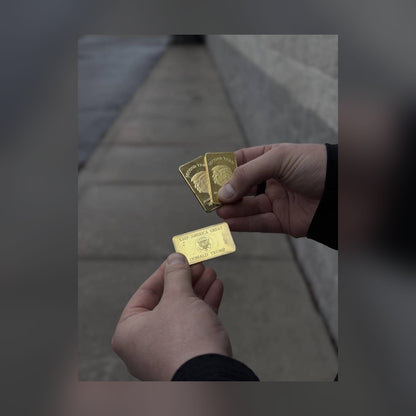 Trump Second Term gold-plated bars held outdoors, front and Keep America Great reverse