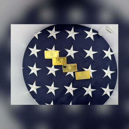 Trump July 13 commemorative gold-plated bars laid on an American flag