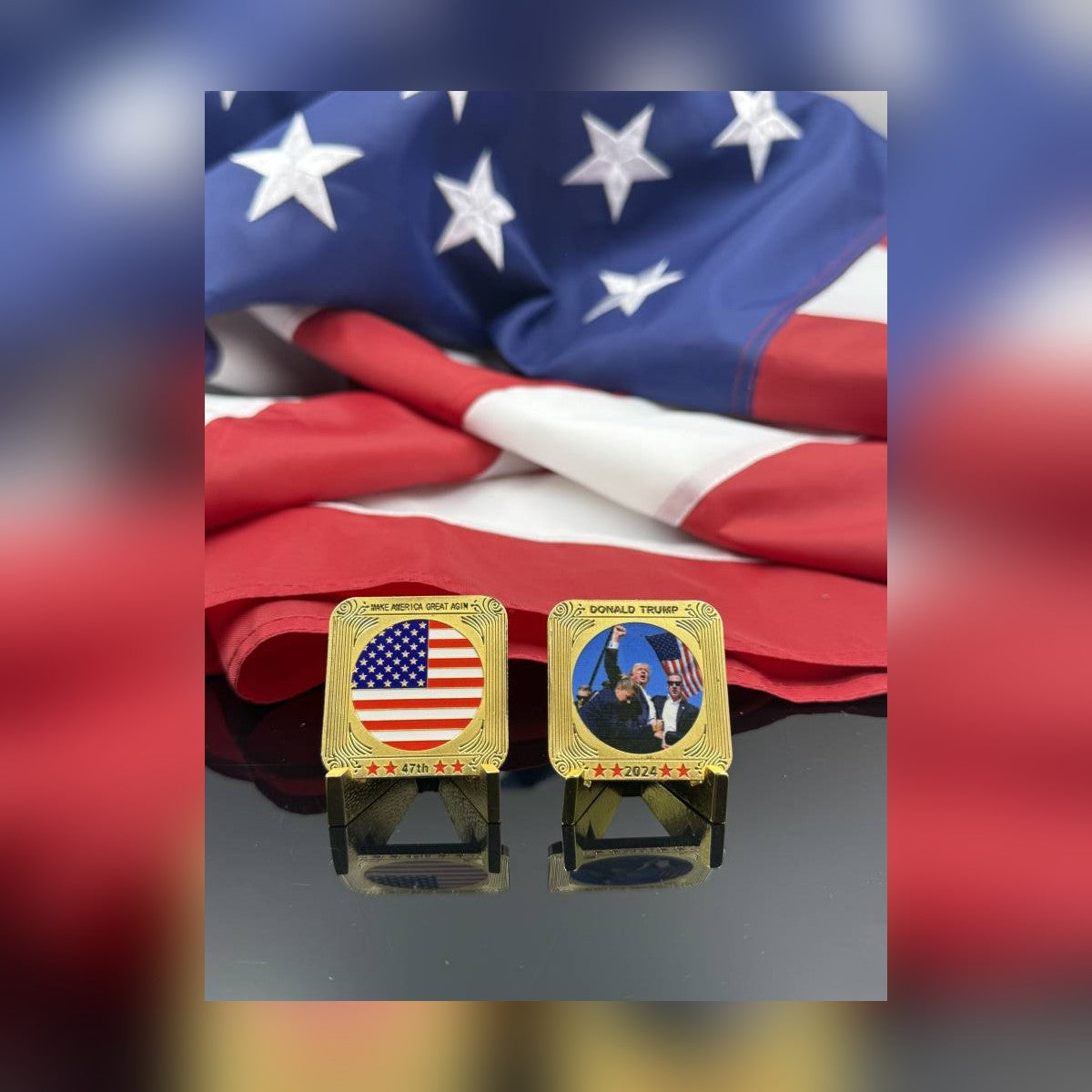 Trump July 13 Square Coin, front and flag back, on small stands in front of an American flag
