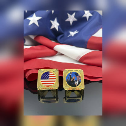 Trump July 13 Square Coin, front and flag back, on small stands in front of an American flag