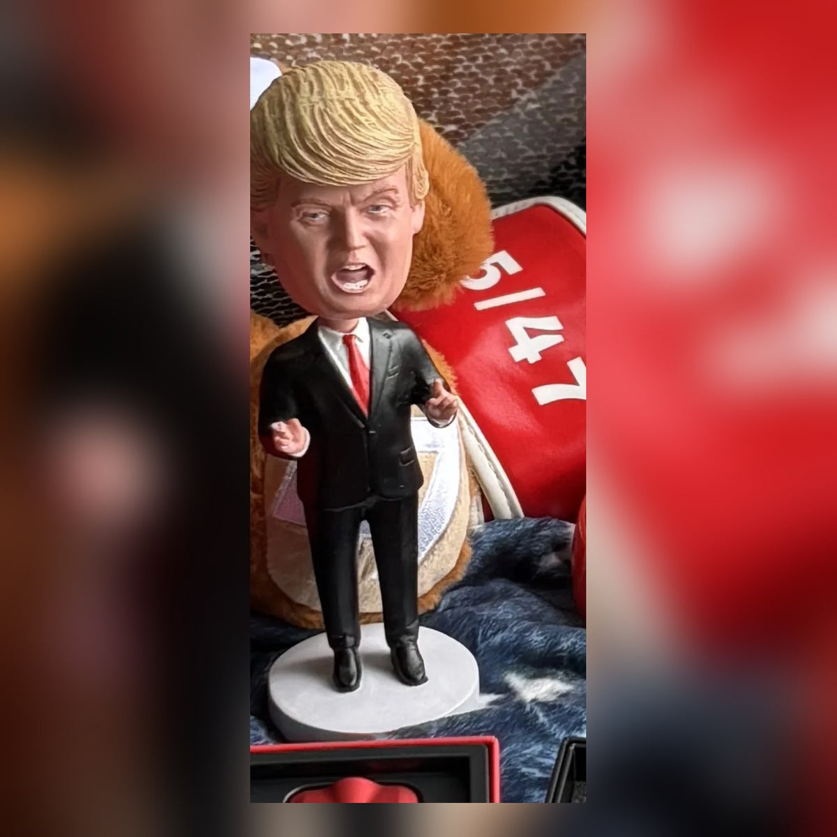 Trump Bobblehead photographed on a patriotic blanket