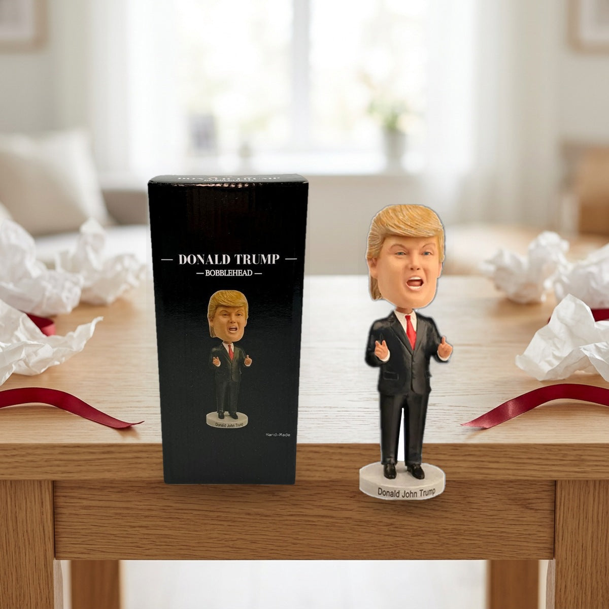 Trump Bobblehead and its box on a side table with gift wrap