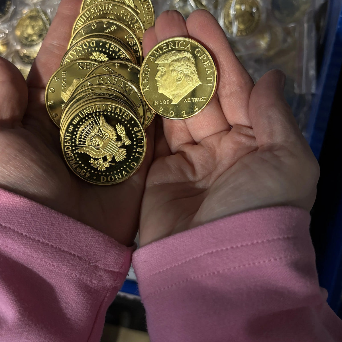 Trump 2024 Keep America Great coins held in two open hands to show their size