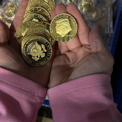 Trump 2024 Keep America Great coins held in two open hands to show their size