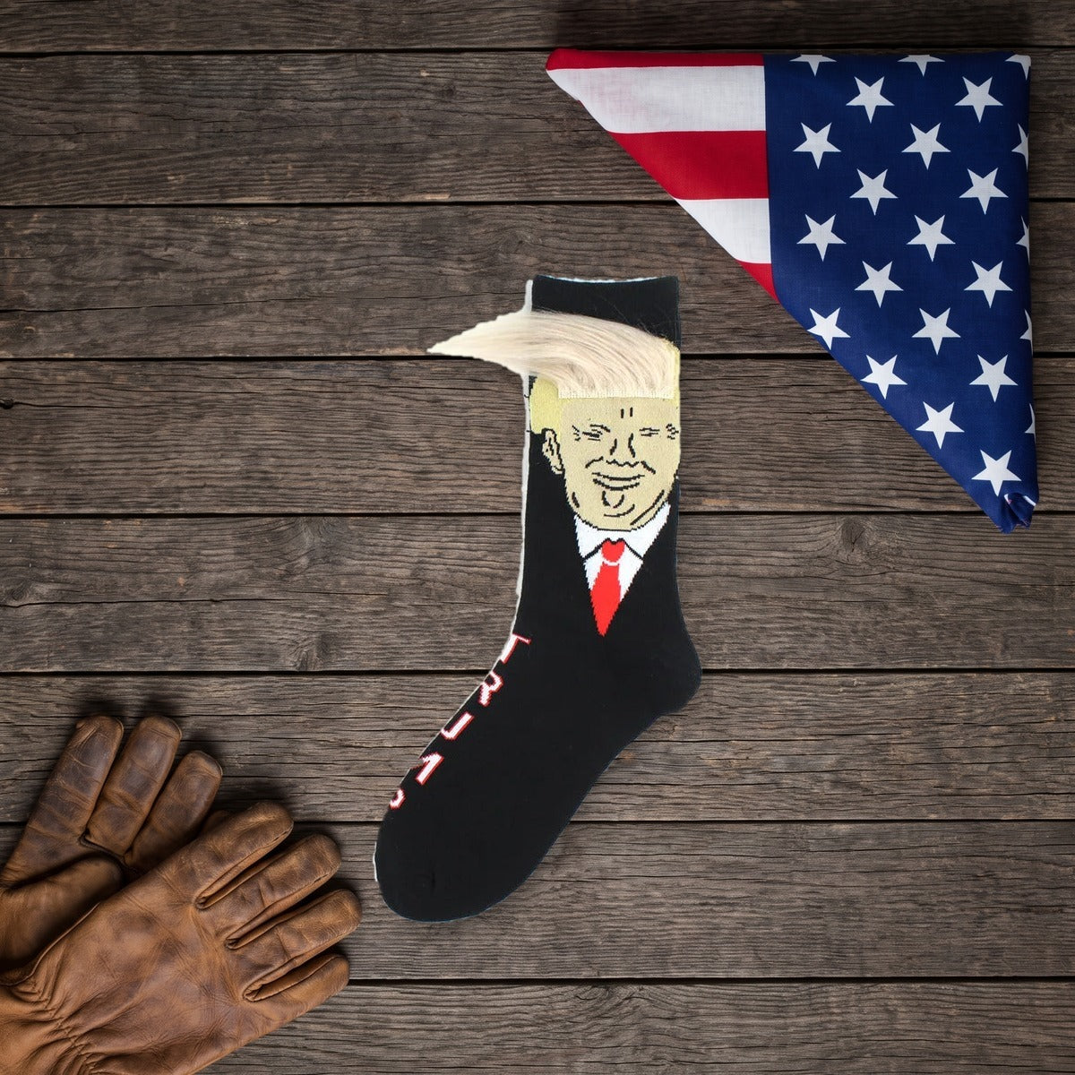Trump Hair Socks on a dark wood table with work gloves