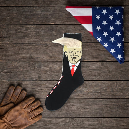 Trump Hair Socks on a dark wood table with work gloves