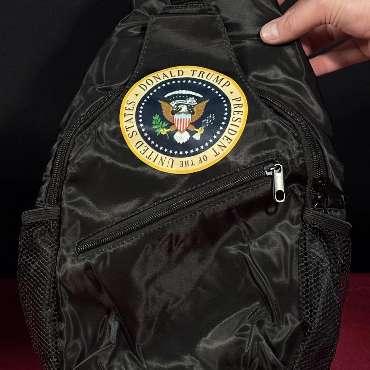 Trump Seal Sling Bag standing upright on a table