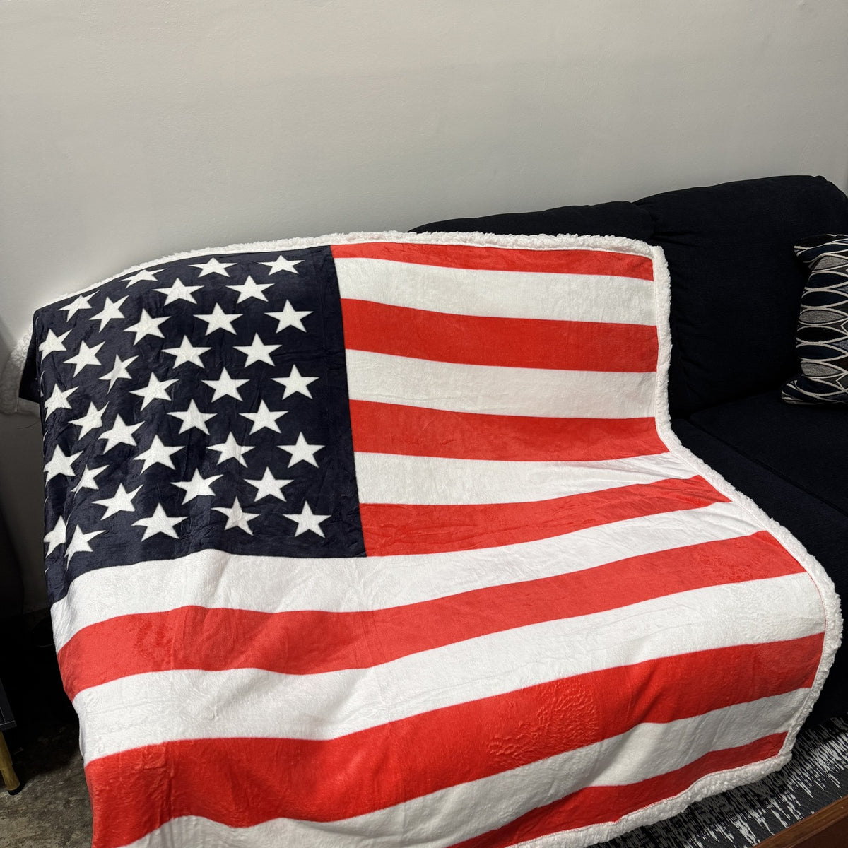 USA Flag Throw Blanket draped over a couch