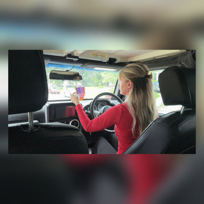 Woman driving with the USA Flag Mini Pennant hanging from the rearview mirror