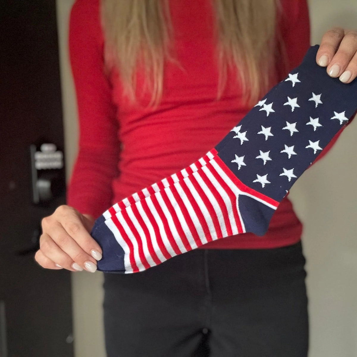Woman holding up one of the USA Flag Socks
