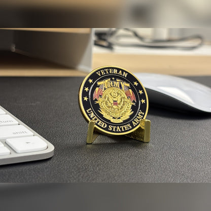 Army Veteran Tribute Coin on a small stand on a desk beside a keyboard