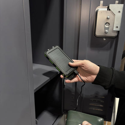 Hand reaching for the Waterproof Solar Charger in a locker cubby