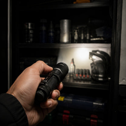 Zoom Torch Flashlight lighting shelves in a dark garage cabinet